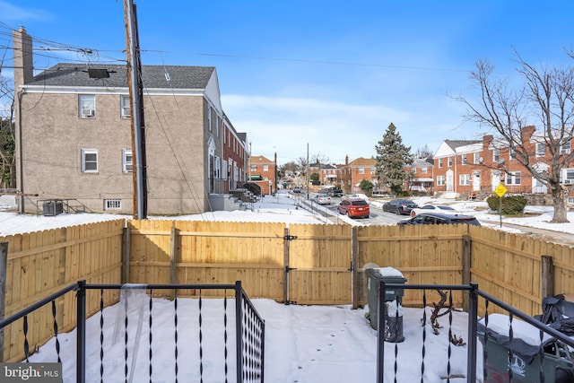 yard covered in snow with central AC unit