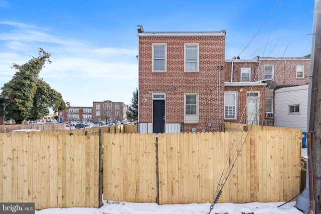 view of snow covered rear of property