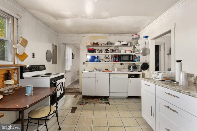 kitchen featuring white cabinetry, light stone counters, white appliances, and a healthy amount of sunlight