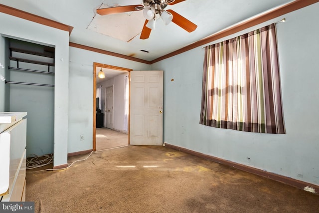 unfurnished bedroom featuring carpet, a closet, crown molding, and ceiling fan