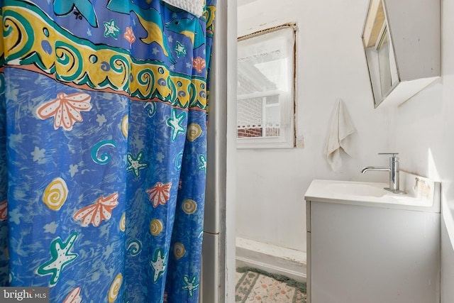 bathroom featuring vanity and a shower with shower curtain