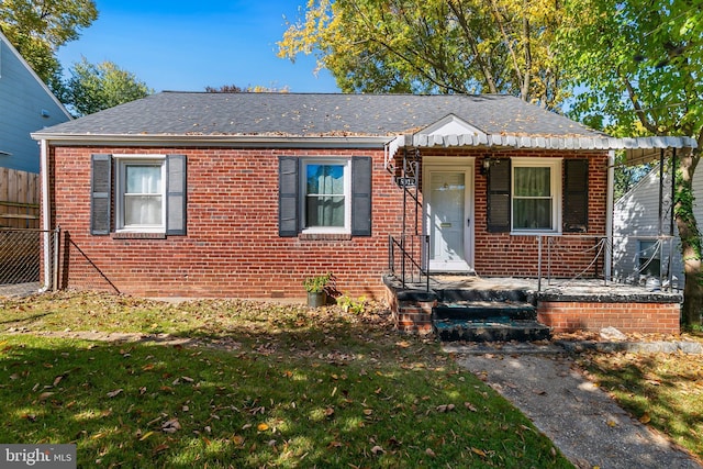 bungalow-style home featuring a front yard