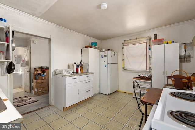 kitchen with stove, white fridge, white cabinetry, and ornamental molding