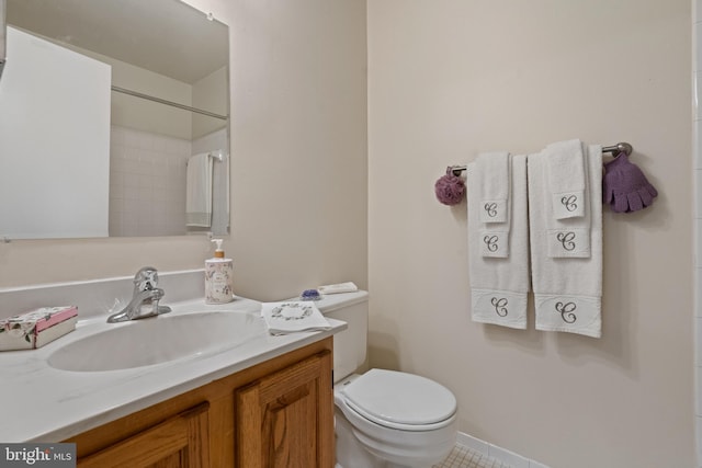 bathroom with toilet, vanity, and a shower