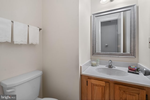 bathroom featuring toilet and vanity