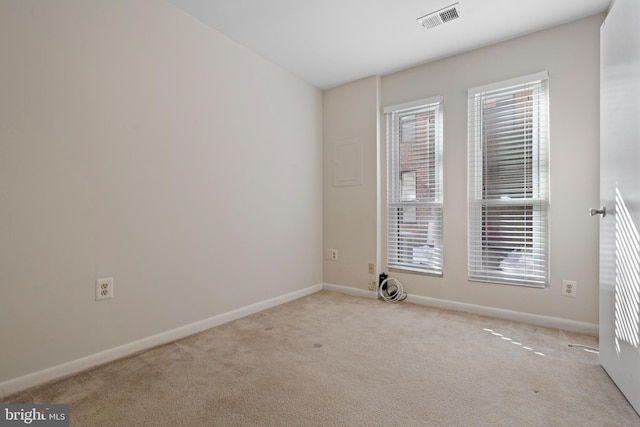 unfurnished room featuring light carpet