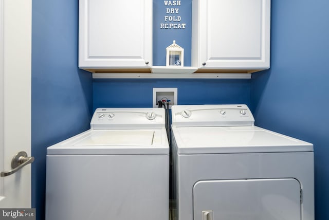 laundry area featuring cabinets and washing machine and clothes dryer