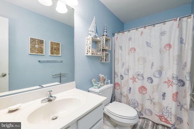 bathroom featuring vanity, a shower with shower curtain, and toilet