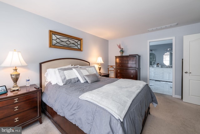 carpeted bedroom with ensuite bath