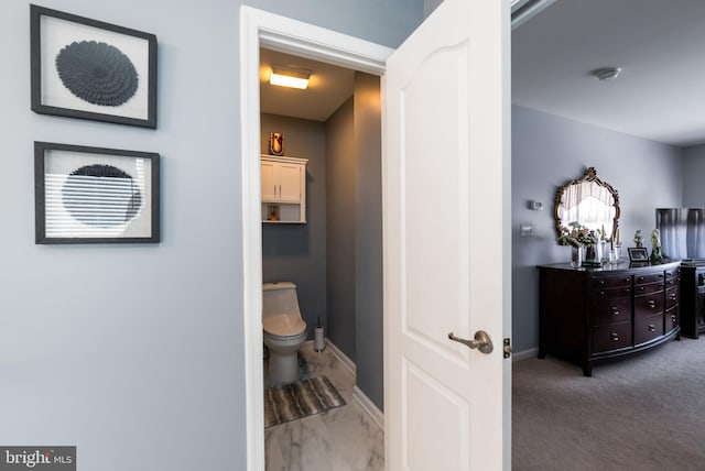 hall with light colored carpet