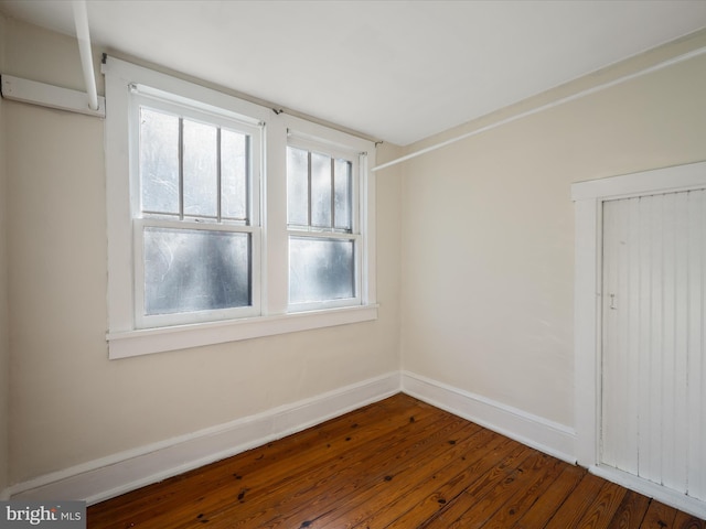 empty room with dark hardwood / wood-style floors