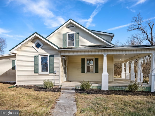 view of front of house featuring a front yard and a porch