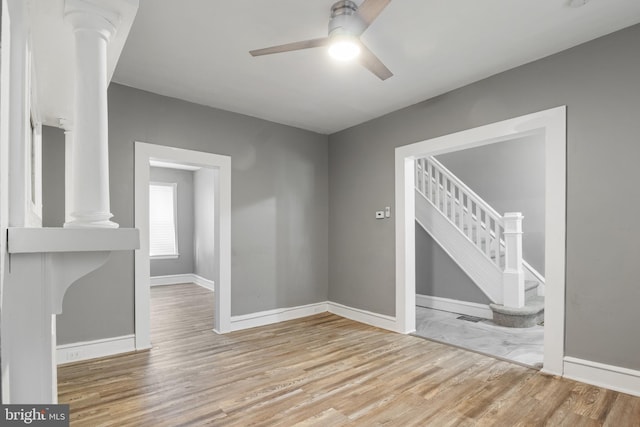 unfurnished living room with ceiling fan and light wood-type flooring