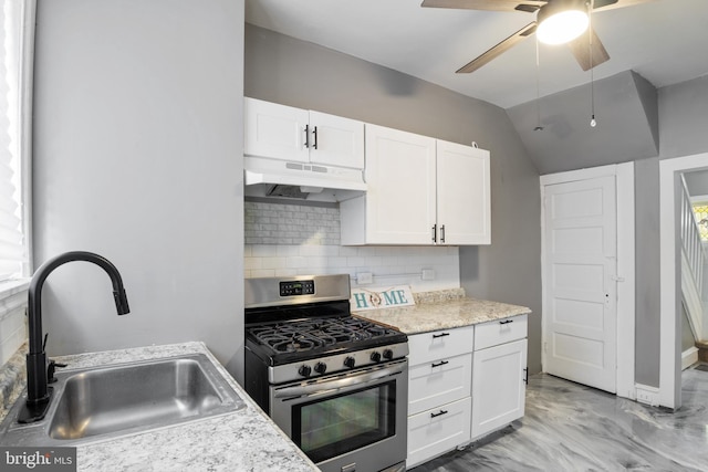 kitchen with decorative backsplash, white cabinetry, sink, and stainless steel gas range