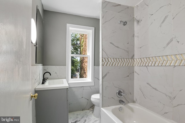 full bathroom with vanity, toilet, tile walls, and bathing tub / shower combination