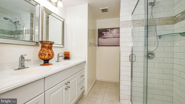 bathroom featuring vanity, tile patterned flooring, and a shower with shower door