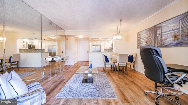 office with an inviting chandelier, crown molding, and light wood-type flooring