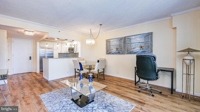 interior space featuring crown molding, light hardwood / wood-style floors, and a textured ceiling