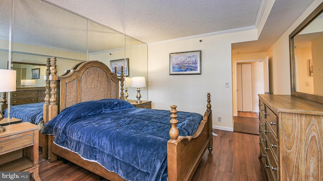 bedroom featuring crown molding, dark hardwood / wood-style floors, and a textured ceiling