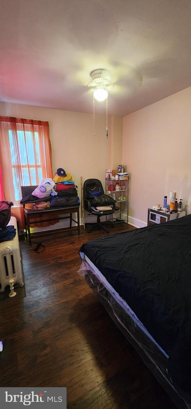 bedroom with hardwood / wood-style flooring and ceiling fan