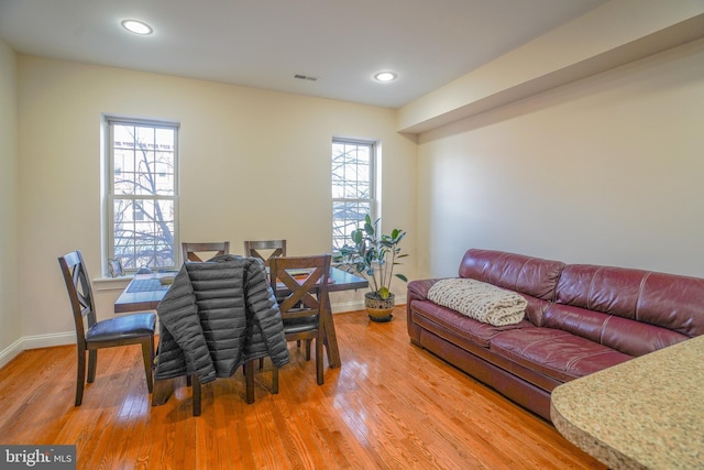 dining room featuring wood-type flooring and a healthy amount of sunlight