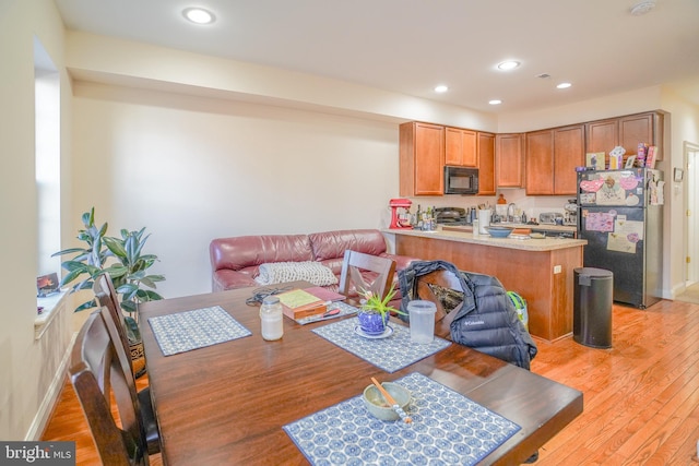 dining area with light hardwood / wood-style floors