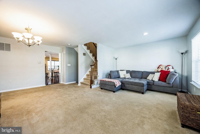 living room featuring light carpet and an inviting chandelier