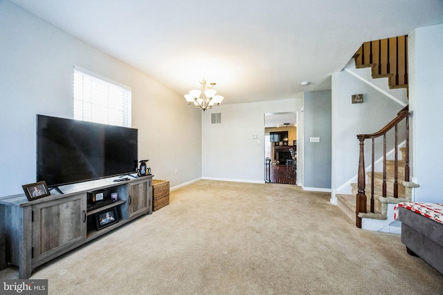 carpeted living room featuring a chandelier