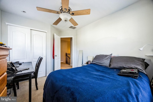 carpeted bedroom featuring ceiling fan and a closet