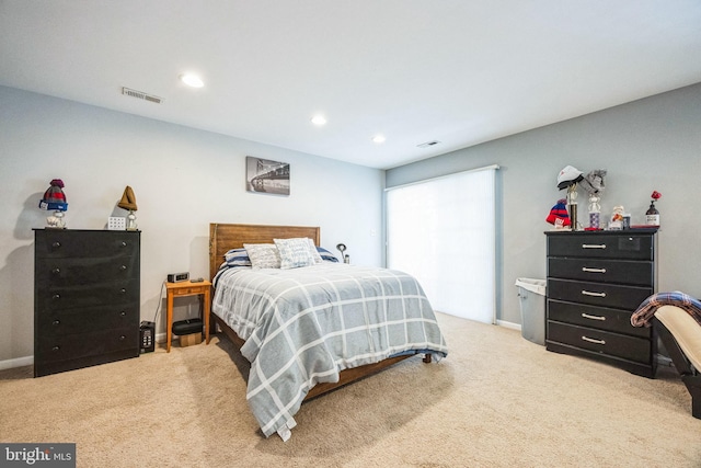 bedroom featuring light colored carpet