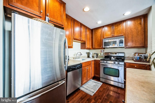 kitchen with dark hardwood / wood-style flooring, sink, and appliances with stainless steel finishes