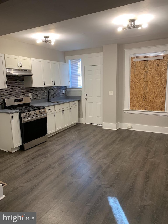 kitchen featuring white cabinetry, sink, stainless steel stove, and dark hardwood / wood-style floors