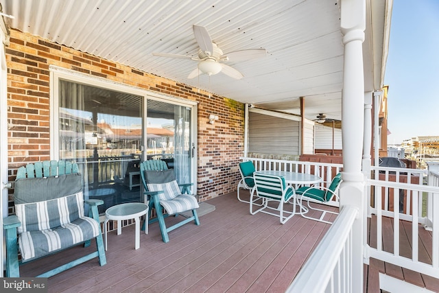 wooden terrace with a ceiling fan