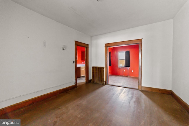 unfurnished room with radiator and hardwood / wood-style flooring