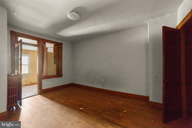 empty room with hardwood / wood-style floors