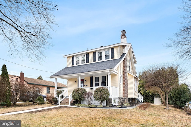 view of front facade with covered porch and a front lawn