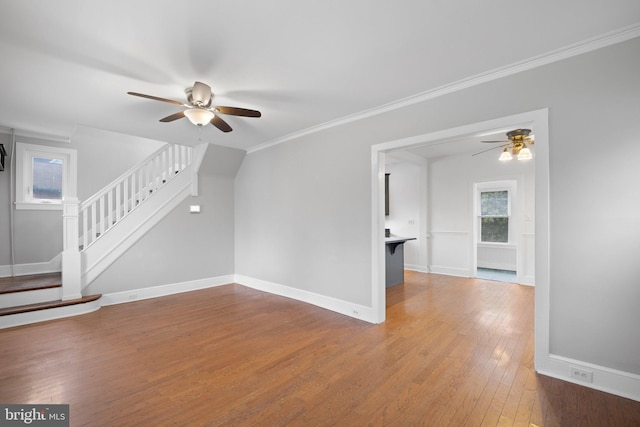 interior space featuring hardwood / wood-style floors, ceiling fan, and crown molding