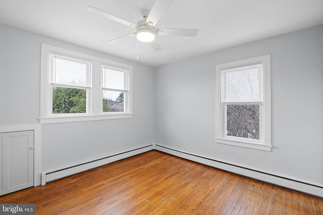 unfurnished room featuring ceiling fan, a baseboard radiator, and light wood-type flooring