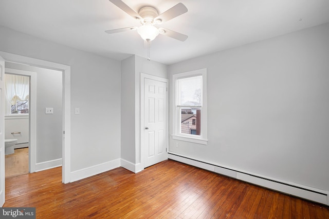 unfurnished bedroom with ceiling fan, a closet, light hardwood / wood-style floors, and a baseboard heating unit