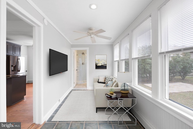 sunroom with ceiling fan