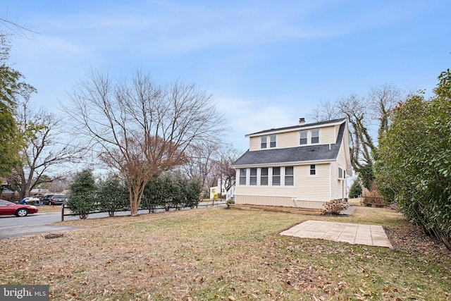 back of house with a lawn