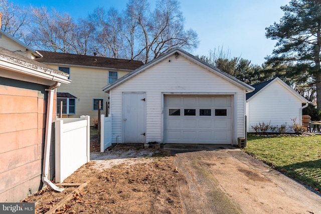 rear view of house with an outbuilding, a yard, and a garage