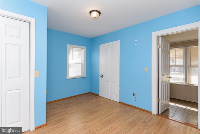 unfurnished bedroom with light wood-type flooring