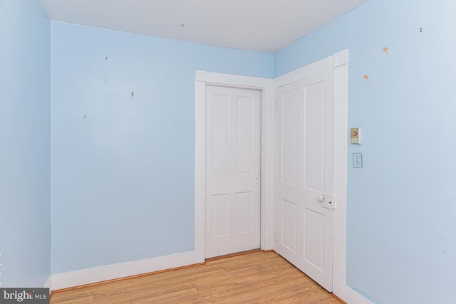 empty room with light hardwood / wood-style flooring