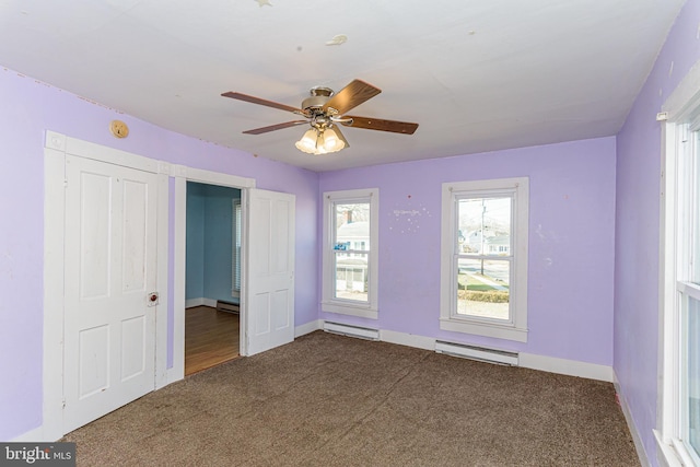 unfurnished bedroom featuring ceiling fan, carpet floors, and a baseboard heating unit