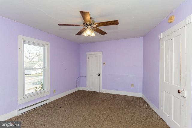 carpeted spare room featuring ceiling fan and baseboard heating