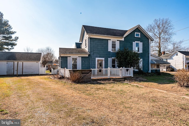 back of property featuring a wooden deck and a lawn