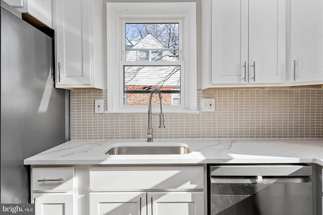 kitchen with white cabinets, stainless steel fridge, sink, and dishwashing machine