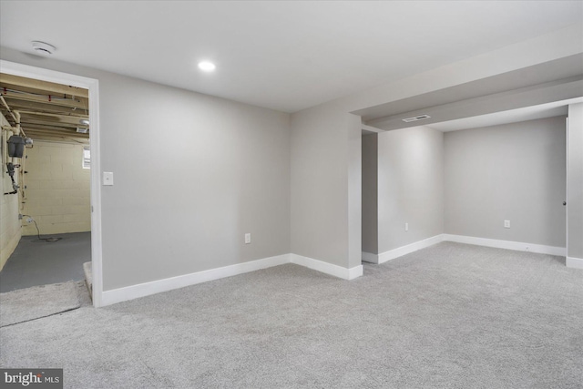 basement featuring light colored carpet