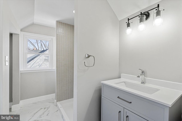 bathroom featuring lofted ceiling, vanity, and walk in shower